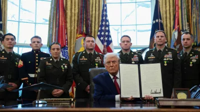 U.S. President Donald Trump shows a signed executive order classifying fentanyl as 'weapon of mass destruction' during a Mexican Border Defense Medal presentation in the Oval Office at the White House in Washington, D.C., U.S., December 15, 2025. REUTERS/Evelyn Hockstein