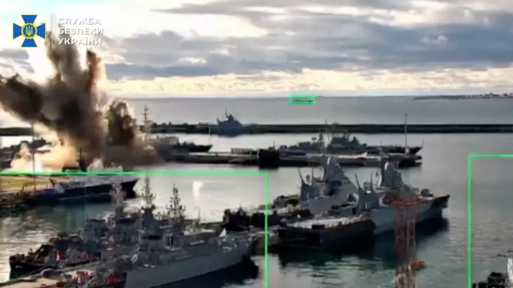 Footage released by the Security Service of Ukraine shows what it says is a strike on a Russian submarine at a port facility, in Novorossiysk, Krasnodar Region, Russia, in this screengrab from video released on December 15, 2025.  Security Service Of Ukraine/Handout via REUTERS  THIS IMAGE HAS BEEN SUPPLIED BY A THIRD PARTY. GRAPHIC OVERLAYS FROM SOURCE. BEST QUALITY AVAILABLE. Verification: - Port layout and piers matched satellite imagery. - Date could not be verified independently.