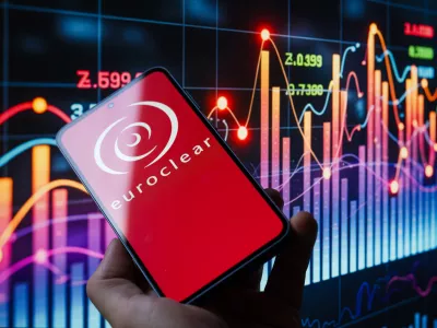 The Euroclear logo is displayed on a mobile phone with a stock graph seen in the background, in this photo illustration in Brussels, Belgium, on October 26, 2025. (Photo by Jonathan Raa/NurPhoto)NO USE FRANCE