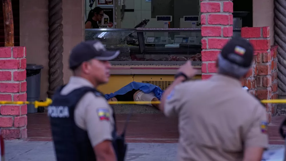 The body of slain soccer player Mario Pineida lies on the floor at a butcher shop in Guayaquil, Ecuador, Wednesday, Dec. 17, 2025. (AP Photo/Cesar Munoz)