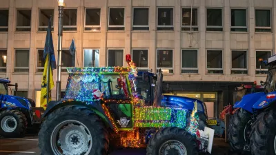 A tractor with holiday lights is parked to block a main boulevard during a demonstration outside a gathering of European leaders at the EU Summit in Brussels, Thursday, Dec. 18, 2025. (AP Photo/Marius Burgelman)