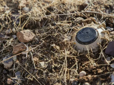 A landmine uncovered by Hoshyar Ali remains partially buried in rocky soil in Halabja, Iraq, on November 20, 2025. He has been clearing landmines for over four decades, a task he began after the Iran-Iraq war when thousands of mines were planted along the border. Despite losing both legs and several family members to explosions, he continues to volunteer in mine removal. Locals call him "man of the mines," and he is building a museum in his village to display defused explosives for future generations.//MIDDLEEASTIMAGES_MEI799/Credit:Showan Sulaiman/MEI/SIPA/2511231254,Image: 1054149849, License: Rights-managed, Restrictions:, Model Release: no