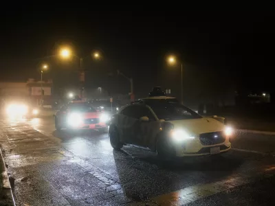 A Waymo vehicle sits idling at an intersection with no operating traffic lights due to power outages, in San Francisco, Saturday, Dec. 20, 2025. (AP Photo/Jeff Chiu)