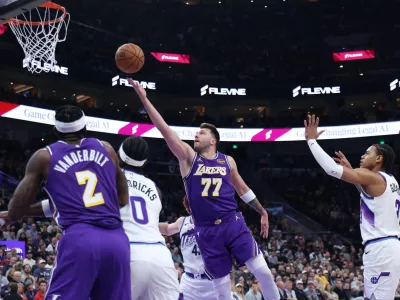 Los Angeles Lakers guard Luka Doncic (77) lays up the ball against the Utah Jazz during the first quarter of an NBA basketball game Thursday, Dec. 18, 2025, in Salt Lake City. (AP Photo/Rob Gray)