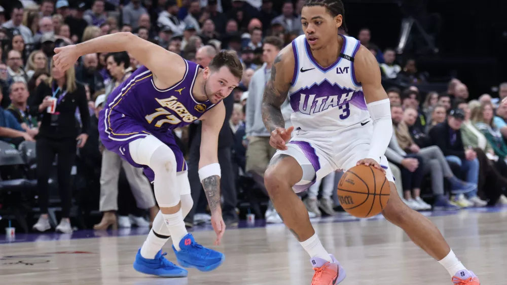 Utah Jazz guard Keyonte George (3) drives to the basket against Los Angeles Lakers guard Luka Doncic (77) during the second half of an NBA basketball game Thursday, Dec. 18, 2025, in Salt Lake City. (AP Photo/Rob Gray)
