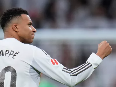 Real Madrid's Kylian Mbappe celebrates after scoring his sides second goal from the penalty spot during the Spanish La Liga soccer match between Real Madrid and Sevilla in Madrid, Spain, Saturday, Dec. 20, 2025. (AP Photo/Manu Fernandez)