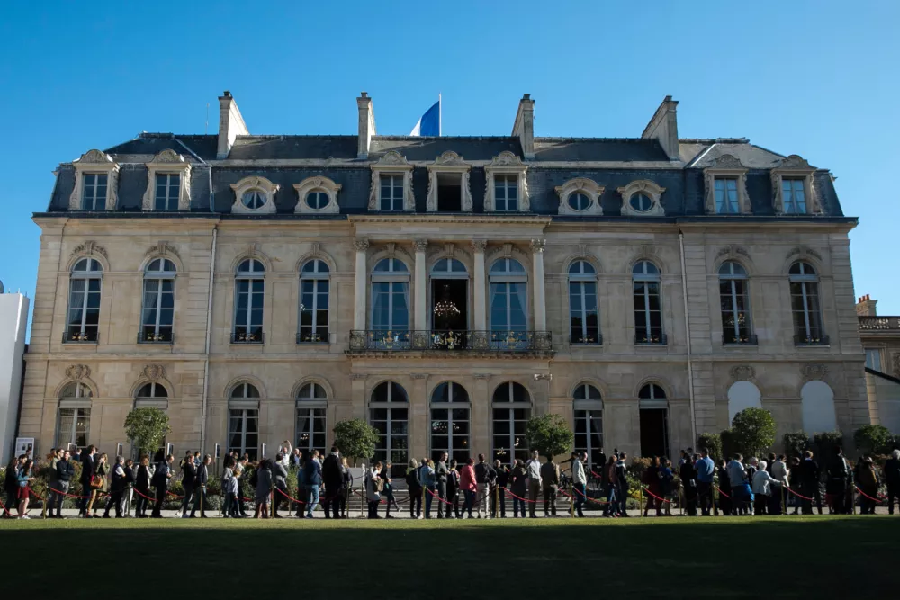 FILE - People queue to visit the Elysee Palace, in Paris, Saturday, Sept 21. 2019. (AP Photo/Kamil Zihnioglu, File)