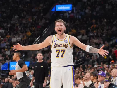 Los Angeles Lakers forward/guard Luka Doncic (77) reacts to a play during the first half of an NBA basketball game against the Los Angeles Clippers Saturday, Dec. 20, 2025, in Inglewood, Calif. (AP Photo/Jae C. Hong)