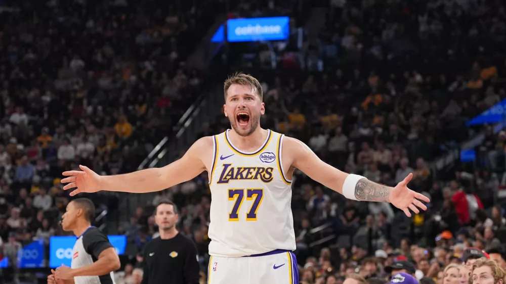 Los Angeles Lakers forward/guard Luka Doncic (77) reacts to a play during the first half of an NBA basketball game against the Los Angeles Clippers Saturday, Dec. 20, 2025, in Inglewood, Calif. (AP Photo/Jae C. Hong)