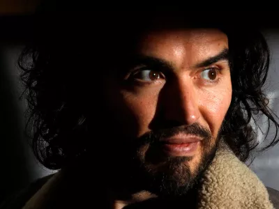 FILE PHOTO: Comedian Russell Brand poses for photographers before signing copies of his new book entitled "Revolution" in central London, December 5, 2014. REUTERS/Suzanne Plunkett/File Photo