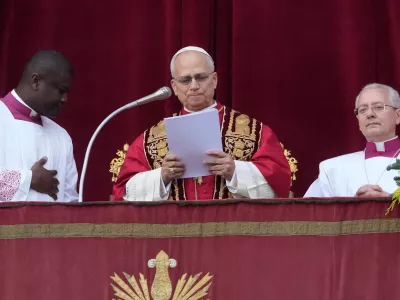 Pope Leo XIV delivers the Urbi et Orbi (Latin for 'to the city and to the world') Christmas' day blessing from the main balcony of St. Peter's Basilica at the Vatican, Thursday, Dec. 25, 2025. (AP Photo/Gregorio Borgia)