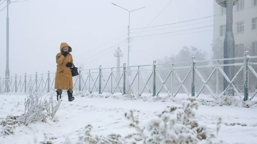 RUSSIA, YAKUTSK - DECEMBER 12, 2025: A woman walk along a snowy street as temperatures plunge to as low as -45C [-43F],Image: 1058697928, License: Rights-managed, Restrictions: * Switzerland And Russia Rights Out *, Model Release: no