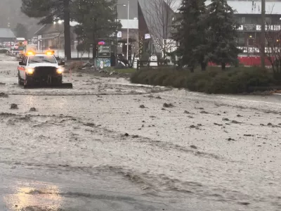 A vehicle moves through a flooded street during torrential rains, in San Bernardino County, California, U.S. December 24, 2025, in this screengrab obtained from a social media video. Damian Nikodem/via REUTERS THIS IMAGE HAS BEEN SUPPLIED BY A THIRD PARTY. MANDATORY CREDIT. NO RESALES. NO ARCHIVES.  VERIFICATION LINES: - Reuters was able to verify the location and date of the video from original file metadata from the source. - The buildings, road layout and business signages matched file imagery of the area.