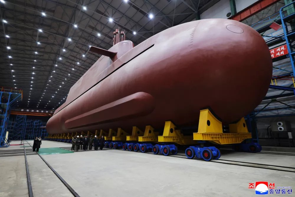 In this undated photo provided Thursday, Dec. 25, 2025, by the North Korean government, its leader Kim Jong Un inspects a nuclear-powered submarine under construction at an undisclosed location in North Korea. Independent journalists were not given access to cover the event depicted in this image distributed by the North Korean government. The content of this image is as provided and cannot be independently verified. Korean language watermark on image as provided by source reads: "KCNA" which is the abbreviation for Korean Central News Agency. (Korean Central News Agency/Korea News Service via AP)