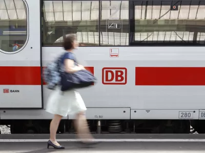A woman walks past a German railway Deutsche Bahn (DB) train at Zurich main railway station July 9, 2010. Swiss Federal Railways (SBB) and DB signed today a memorandum of understanding to reinforce their cooperation. REUTERS/Arnd Wiegmann (SWITZERLAND - Tags: BUSINESS TRANSPORT TRAVEL)