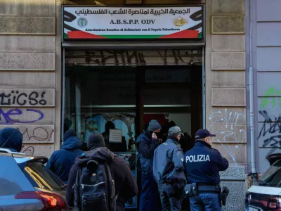 Police officers inspect a charitable association supporting Palestinian civilians in Milan, Italy, Saturday, Dec. 27, 2025 after Italian investigators have arrested nine people suspected of raising millions of euros for Hamas. (Claudio Furlan/LaPresse via AP)