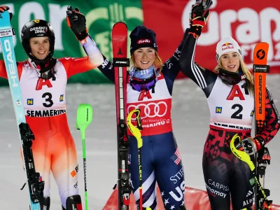 United States' Mikaela Shiffrin, center, winner of an alpine ski, women's World Cup slalom, poses with second placed Switzerland's Camille Rast, left, and third placed Albania's Lara Colturi, in Semmering, Austria, Sunday, Dec. 28, 2025. (AP Photo/Pier Marco Tacca)