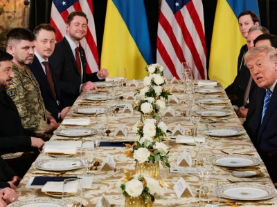 Ukrainian President Volodymyr Zelenskiy reacts as U.S. President Donald Trump, with Secretary of State Marco Rubio, Trump's son-in-law Jared Kushner, U.S. Special Envoy Steve Witkoff and White House Chief of Staff Susan Wiles, speaks during a meeting with a Ukrainian delegation led by Zelenskiy, at Trump's Mar-a-Lago club in Palm Beach, Florida, U.S., December 28, 2025. REUTERS/Jonathan Ernst    TPX IMAGES OF THE DAY