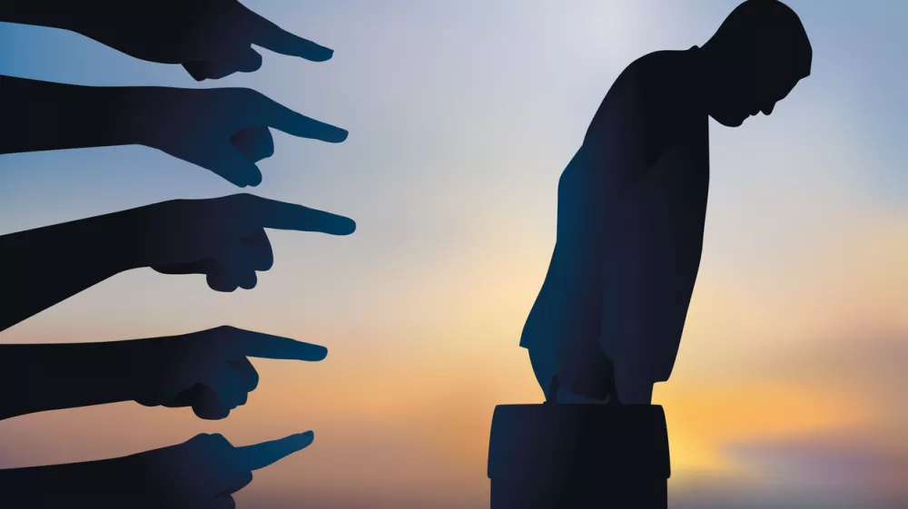 Concept of arbitrary dismissal and discrimination with a man singled out and accused before being fired from work.