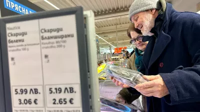 FILE PHOTO: People shop in a Lidl store, as prices are displayed in both the Bulgarian lev and euro currencies, ahead of Bulgaria's adoption of the euro on January 1, 2026, in Sofia, Bulgaria, December 18, 2025. REUTERS/Fedja Grulovic/File Photo