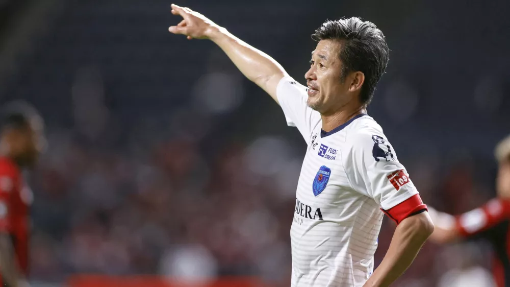 FILE PHOTO: Yokohama FC's Japanese striker Kazuyoshi Miura who is recognised as the world's oldest goalscorer and oldest player currently playing in a professional league, gestures during J. League YBC Levain Cup soccer match against Hokkaido Consadole Sapporo in Sapporo, northern Japan August 12, 2020, in this photo taken by Kyodo. Picture taken August 12, 2020. Mandatory credit Kyodo/via REUTERS ATTENTION EDITORS - THIS IMAGE WAS PROVIDED BY A THIRD PARTY. MANDATORY CREDIT. JAPAN OUT. NO COMMERCIAL OR EDITORIAL SALES IN JAPAN./File Photo