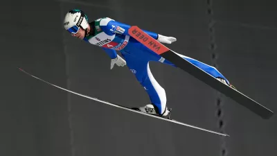 Timi Zajc, of Slovenia, soars through the air during his first round jump at the first stage of the Four Hills ski jumping tournament in Oberstdorf, Germany, Monday, Dec. 29, 2025. (AP Photo/Matthias Schrader)
