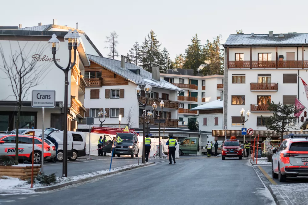 Police officers inspect the area where a fire broke out at the Le Constellation bar and lounge leaving people dead and injured, during New Year's celebration, in Crans-Montana, Swiss Alps, Switzerland, Thursday, Jan. 1, 2026. (Alessandro della Valle/Keystone via AP)