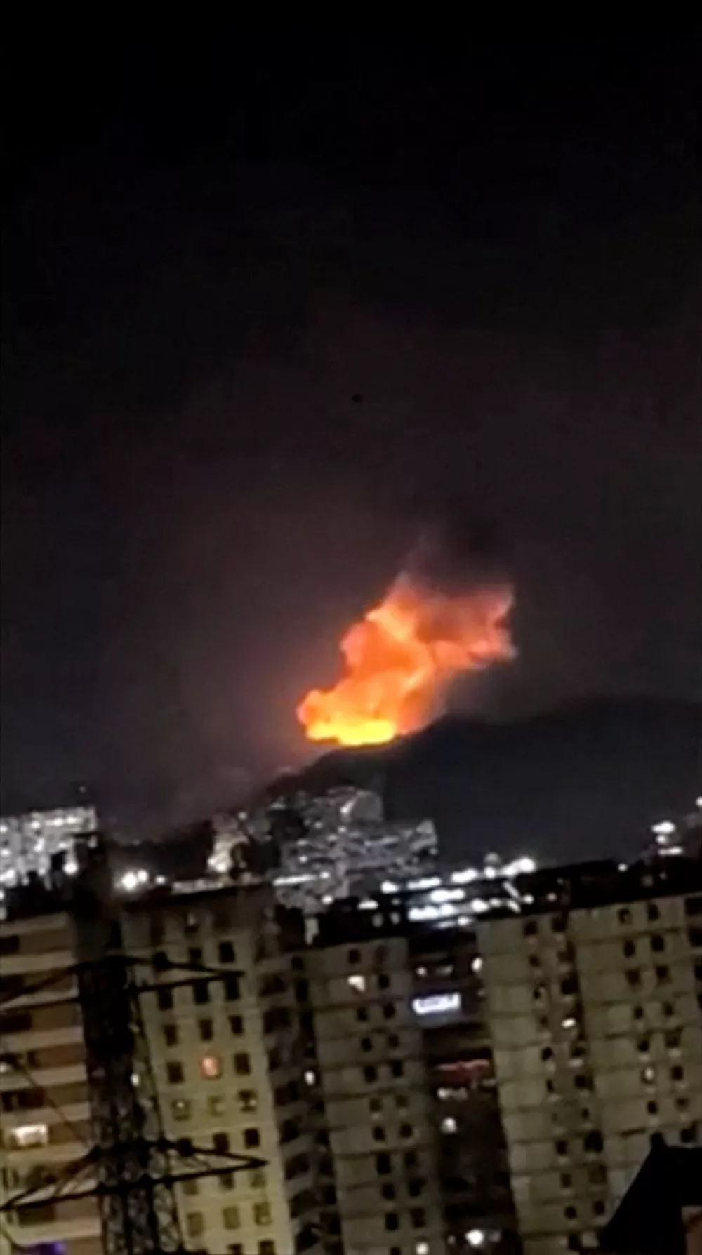 A column of smoke rises during multiple explosions in the early hours of the morning, in Caracas, Venezuela, January 3, 2026 in this screen grab obtained from video obtained by Reuters. Video Obtained by Reuters/via REUTERS THIS IMAGE HAS BEEN SUPPLIED BY A THIRD PARTY.