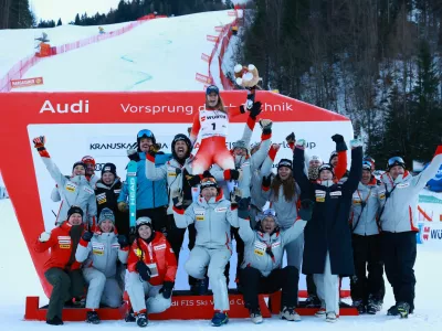 Alpine Skiing - FIS Alpine Ski World Cup - Women's Giant Slalom - Kranjska Gora, Slovenia - January 3, 2026 Switzerland's Camille Rast celebrates on the podium with her team after winning the women's giant slalom REUTERS/Borut Zivulovic