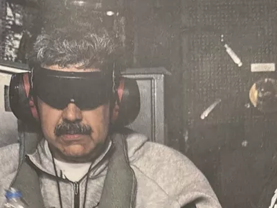 A photograph which U.S. President Donald Trump posted on his Truth Social account shows what he describes as Venezuelan President "Nicolas Maduro on board the USS Iwo Jima" amphibious assault ship, currently in the Caribbean Sea January 3, 2026. The image appears to be taken from a printed photograph, as white edging can be seen around the image. What appears to be the letters DEA can be seen on a black uniformed person next to Venezuelan president Maduro. U.S. president Trump said DEA officials were involved in the operation. Verifying the location was not immediately possible as the photograph is tightly cropped. But the patterning of grey hairs within Maduro's mustache matched recent imagery of him. @realDonaldTrump/Handout via REUTERS THIS IMAGE HAS BEEN SUPPLIED BY A THIRD PARTY. THIS PICTURE WAS PROCESSED BY REUTERS TO ENHANCE QUALITY. AN UNPROCESSED VERSION HAS BEEN PROVIDED SEPARATELY.