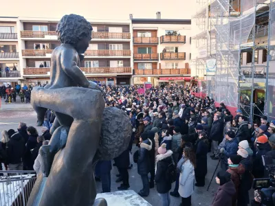 People stand outside the Chapelle St-Christophe during a memorial mass in Crans-Montana, Swiss Alps, Switzerland, Sunday, Jan. 4, 2026, after a devastating fire in Le Constellation bar left dead and injured during the New Year's celebrations. (AP Photo/ Antonio Calanni)