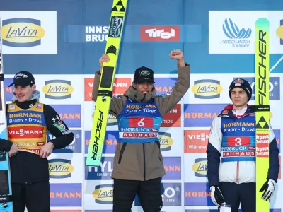 Ski Jumping - Four Hills Tournament - Innsbruck, Austria - January 4, 2026 Japan's Ren Nikaido celebrates on the podium after winning the Men's Individual HS128 alongside second place Slovenia's Domen Prevc and third place Austria's Stephan Embacher REUTERS/Kai Pfaffenbach