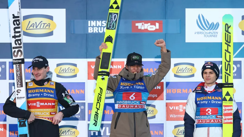 Ski Jumping - Four Hills Tournament - Innsbruck, Austria - January 4, 2026 Japan's Ren Nikaido celebrates on the podium after winning the Men's Individual HS128 alongside second place Slovenia's Domen Prevc and third place Austria's Stephan Embacher REUTERS/Kai Pfaffenbach