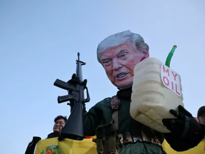 An activist, wearing a cutout mask depicting U.S. President Donald Trump, holds a toy gun and a container with the words, "My Oil" during an anti-Trump rally to condemn the U.S. conducting a military act on Venezuela to capture its President Nicolas Maduro and his wife Cilia Flores, in central Seoul, South Korea, January 5, 2026. REUTERS/Kim Hong-Ji   TPX IMAGES OF THE DAY