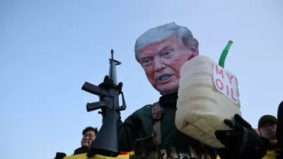 An activist, wearing a cutout mask depicting U.S. President Donald Trump, holds a toy gun and a container with the words, "My Oil" during an anti-Trump rally to condemn the U.S. conducting a military act on Venezuela to capture its President Nicolas Maduro and his wife Cilia Flores, in central Seoul, South Korea, January 5, 2026. REUTERS/Kim Hong-Ji   TPX IMAGES OF THE DAY
