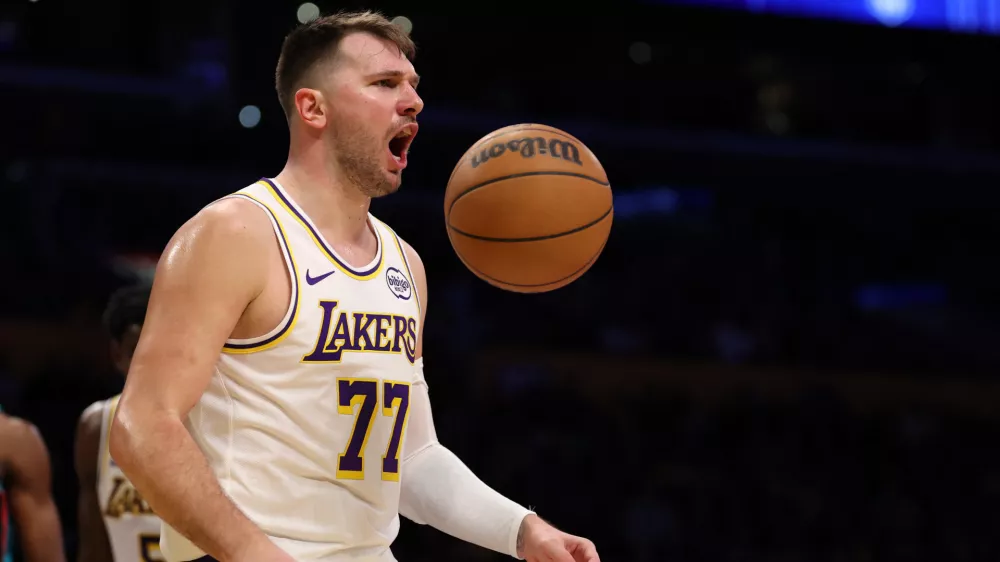 Jan 4, 2026; Los Angeles, California, USA; Los Angeles Lakers guard Luka Doncic (77) reacts to a play during the third quarter against the Memphis Grizzlies at Crypto.com Arena. Mandatory Credit: Kiyoshi Mio-Imagn Images