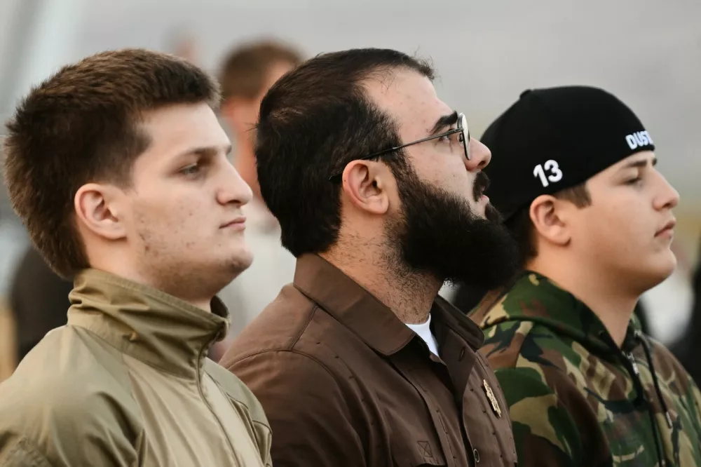8289270 04.10.2022 Head of Chechen Republic Ramzan Kadyrov's sons: Akhmat, left, Adam, right, and Chechen Republic's Sports Minister Khamzat Kadyrov, center, attend an opening ceremony of skydiving competition, in Gudermes, Russia's Chechen Republic.,Image: 728093365, License: Rights-managed, Restrictions: Editors' note: THIS IMAGE IS PROVIDED BY RUSSIAN STATE-OWNED AGENCY SPUTNIK., Model Release: no