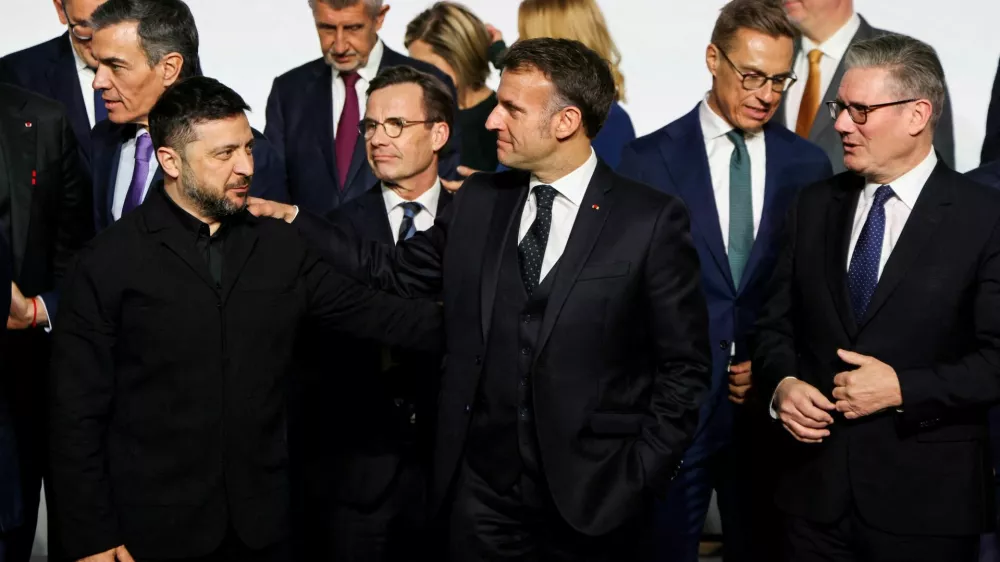Ukraine's President Volodymyr Zelenskiy, France's President Emmanuel Macron and Britain's Prime Minister Keir Starmer react as they stand for a family photo, on the sideline of the so-called 'Coalition of the Willing' summit, at the Elysee Palace in Paris, France, January 6, 2026. Ludovic Marin/Pool via REUTERS
