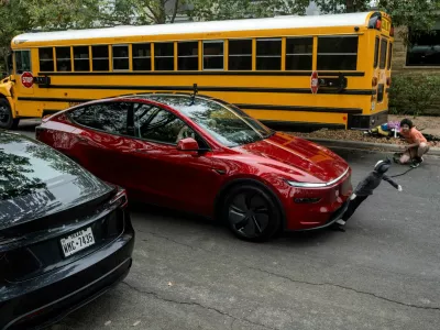 FILE PHOTO: Arthur Maltin, a test driver with The Dawn Project, hits a crash dummy as it crosses the road during a safety test on a Tesla Model Y's self-driving feature at a protest against Tesla robotaxis, ahead of the Tesla robotaxis' official services in Austin, Texas, U.S., June 12, 2025.  REUTERS/Joel Angel Juarez/File Photo