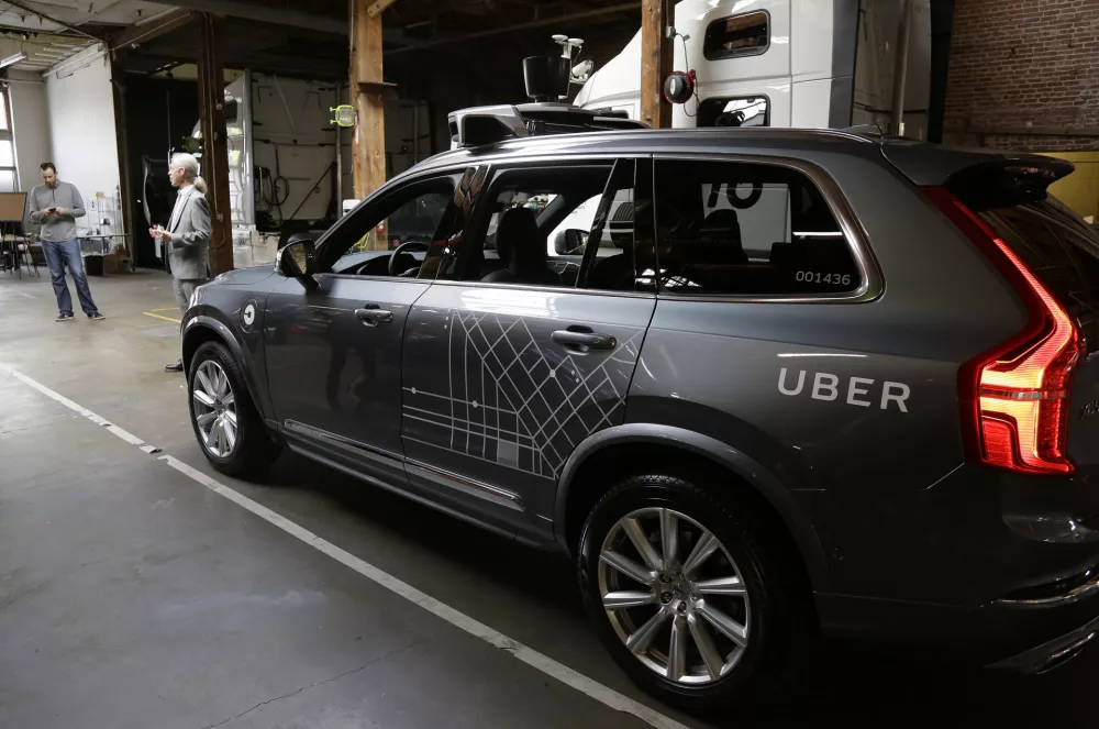 FILE - In this Dec. 13, 2016 file photo, an Uber driverless car is displayed in a garage in San Francisco. Uber suspended all of its self-driving testing Monday, March 19, 2018, after what is believed to be the first fatal pedestrian crash involving the vehicles. The testing has been going on for months in the Phoenix area, Pittsburgh, San Francisco and Toronto as automakers and technology companies compete to be the first with the technology. Uber's testing was halted after police in a Phoenix suburb said one of its self-driving vehicles struck and killed a pedestrian overnight Sunday. (AP Photo/Eric Risberg, File)