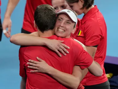 Elise Mertens of Belgium celebrates with teammates after her win over Barbora Krejcikova of Czechia in their women's singles quarterfinal match at the United Cup tennis tournament in Sydney, Thursday, Jan. 8, 2026. (AP Photo/Rick Rycroft)