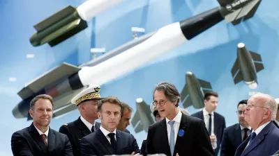 FILE PHOTO: French President Emmanuel Macron listens to CEO of Safran Olivier Andries as French Minister for Industry and Energy Marc Ferracci, and Ross McInnes, Chairman of the Board of Safran, look on at the stand of aerospace and defence company Safran during a visit at the 55th International Paris Airshow at Le Bourget Airport near Paris, France, June 20, 2025. REUTERS/Benoit Tessier/Pool/File Photo