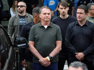 FILE PHOTO: Former Brazilian President Jair Bolsonaro leaves the hospital where he went to undergo a skin surgery procedure, authorized by Supreme Court Justice Alexandre de Moraes, leaving the house arrest after being convicted by a Supreme Court majority of plotting a coup to remain in power after losing the 2022 election, in Brasilia, Brazil, September 14, 2025. REUTERS/Adriano Machado  TPX IMAGES OF THE DAY/File Photo