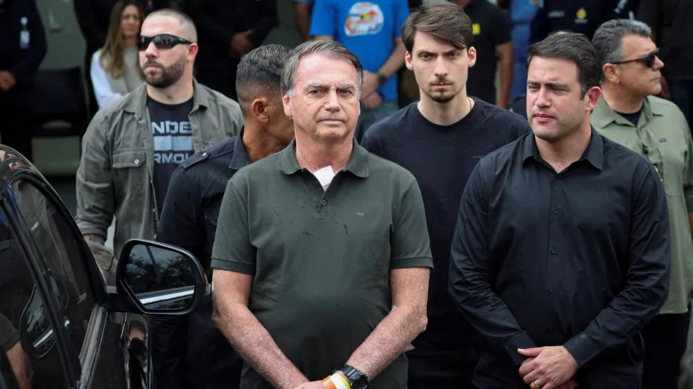 FILE PHOTO: Former Brazilian President Jair Bolsonaro leaves the hospital where he went to undergo a skin surgery procedure, authorized by Supreme Court Justice Alexandre de Moraes, leaving the house arrest after being convicted by a Supreme Court majority of plotting a coup to remain in power after losing the 2022 election, in Brasilia, Brazil, September 14, 2025. REUTERS/Adriano Machado  TPX IMAGES OF THE DAY/File Photo