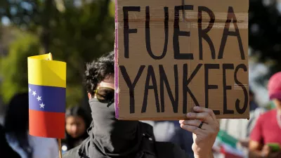 A man holds a placard reading "Yankees out", as protesters gather outside the U.S. embassy, after U.S. President Donald Trump said that the U.S. attacked Venezuela and deposed its President Nicolas Maduro, in Mexico City, Mexico January 3, 2026. REUTERS/Toya Sarno Jordan