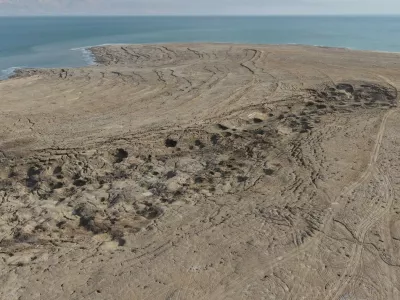 An aerial drone photo taken on January 4, 2026 shows a view of the sinkholes at the Dead Sea near Ein Gedi beach in Israel. Statistics showed that the Dead Sea had been shrinking at an alarming pace, its water level dropping by 1.2 meters each year. As the water receded, a barren landscape of salt rock and numerous sinkholes appeared. The proliferation of sinkholes along the Dead Sea shores remains one of Israel's most pressing environmental challenges. As of 2025, there are over 7,000 documented sinkholes, a number that continues to grow at a rate of several hundred per year.The rapid retreat of the Dead Sea is transforming the coastline and creating hazardous sinkholes.//04SIPA_sipa.41600/Credit:GIL COHEN-MAGEN/SIPA/2601071423,Image: 1063981066, License: Rights-managed, Restrictions:, Model Release: no