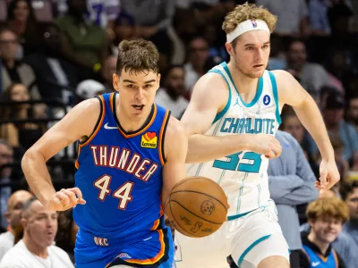 FILE - Oklahoma City Thunder guard Nikola Topic, left, drives the ball upcourt against Charlotte Hornets forward Liam McNeeley, right, during the second half of an NBA basketball preseason game in North Charleston, S.C., Sunday, Oct. 5, 2025. (AP Photo/Mic Smith, File)