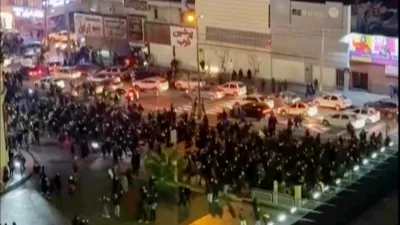 In this frame grab from video taken by an individual not employed by The Associated Press and obtained by the AP outside Iran shows people blocking an intersection during a protest in Tehran, Iran, Thursday Jan. 8, 2026. (UGC via AP)