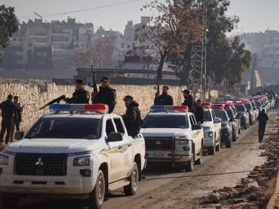 A Syrian police convoy gathers in the Sheikh Maqsoud neighborhood, where clashes between government forces and Kurdish fighters have been taking place in the northern city of Aleppo, Syria, Saturday, Jan. 10, 2026. (AP Photo/Omar Albam)