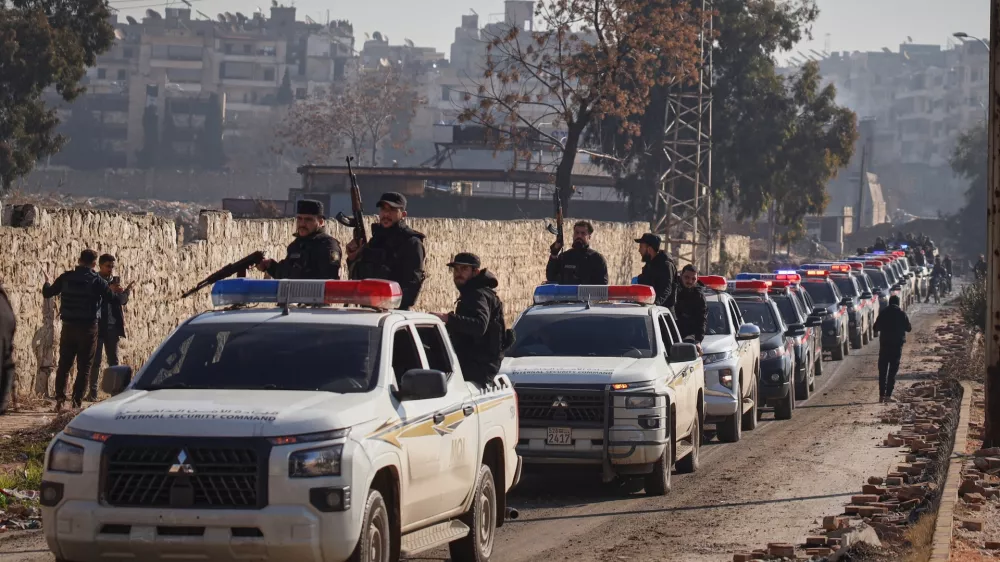 A Syrian police convoy gathers in the Sheikh Maqsoud neighborhood, where clashes between government forces and Kurdish fighters have been taking place in the northern city of Aleppo, Syria, Saturday, Jan. 10, 2026. (AP Photo/Omar Albam)